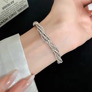 Close-up of a elegant multi-layer rhinestone twisted geometric bracelet on a woman wrist