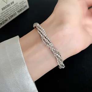 Detail of multi-layer silver twisted bracelet with sparkling rhinestones on wrist
