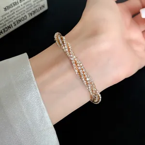 Detail macro view of multi-layer twisted bracelet with sparkling rhinestones on wrist