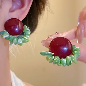 Elegant vintage burgundy stud earrings featuring decorative green crushed stone shell fringe