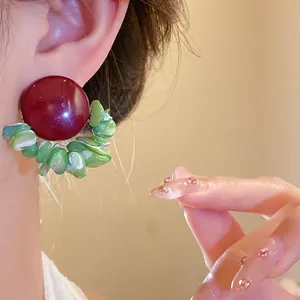 Elegant retro silver needle earrings with burgundy stud and green shell petals detail.