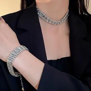 Luxurious sparkling rhinestone choker necklace and matching bracelet set for evening wear.