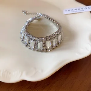 Detail view of elegant silver-tone choker featuring emerald-cut and round clear rhinestones