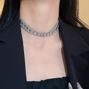 Detailed macro view of high-quality silver geometric rhinestone choker worn by model