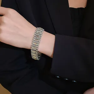 Detailed view of an elegant geometric silver-toned rhinestone bracelet on a model's wrist
