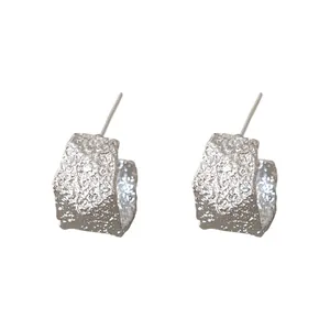Pendientes de aro en forma de C plateados con un diseño texturizado minimalista y elegante