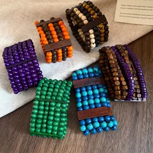 Ethnic style multi-layered wooden bead bracelets in vibrant colors on rustic background deco