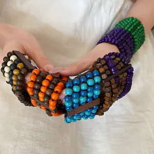 Close-up detail of multi-color layered wooden bead bracelets in ethnic retro style