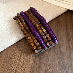 Detail view of ethnic multi-layer bracelet with purple and brown wooden beads.