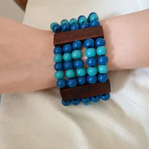 Detail showing the texture of the ethnic multi-layer wooden beaded bracelet on wrist.
