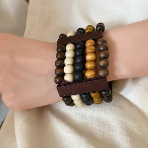 Close-up detail of a retro multi-layer ethnic style wooden bead bracelet on a person's wrist