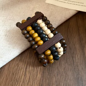 Close-up of ethnic style multilayer wooden beaded bracelet on rustic wood background