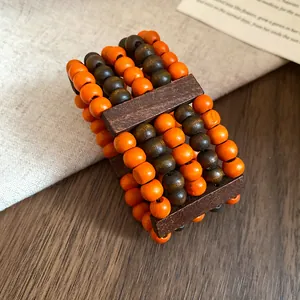 Detailed view of handmade multi-strand ethnic retro style orange and brown wooden bead bracelet