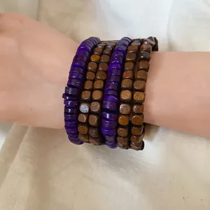Close-up of multi-layer ethnic style bracelet with purple and brown wood beads