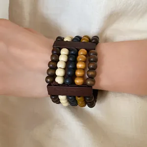 Ethnic style multilayer wooden bead bracelet featuring retro earthy tones on model wrist