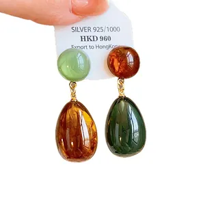 Elegant asymmetric resin teardrop earrings with silver pins in a vintage Hong Kong style