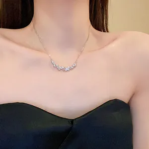 Detail view of an elegant teardrop cubic zirconia necklace worn by a model for a chic style