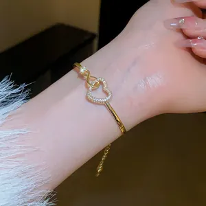 Detailed macro view of a gold hollow heart bracelet paved with shimmering zirconia stones