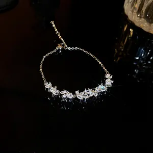 Detailed close-up of sparkling marquise-cut zircon clusters on a delicate silver chain.