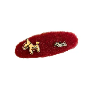 Vintage red flocked hair clip with golden pony charm and handmade label accessory