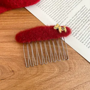 Detail of vintage red flocked hair comb featuring a gold pony charm and metal tines
