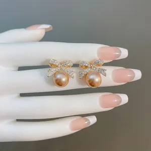 French vintage silver needle earrings featuring rhinestone bow and large cream pearls