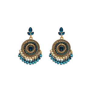 Vintage ethnic style gold earrings with blue rhinestones and turquoise bead tassels.