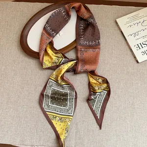 Detailed view of a vintage paisley printed silk scarf necklace styled in warm earth tones.