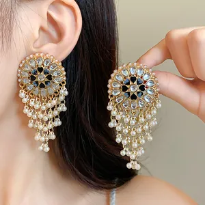 Detailed view of ornate ethnic-style earrings with pearls and crystal tassels