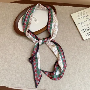 Close-up of retro printed fabric scarf with geometric patterns in green and red.