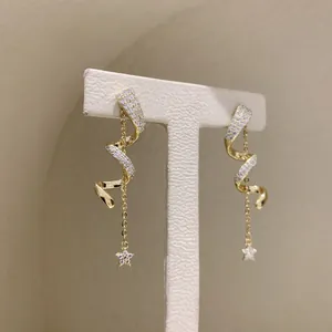 Elegant gold-plated spiral drop earrings with sparkling stars and chain detail