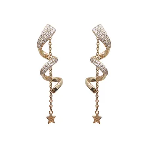 Elegant gold-tone spiral earrings featuring star chain charms and sparkling pave rhinestones
