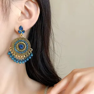 Detail view of retro ethnic style round dangle earrings with blue rhinestones and beads