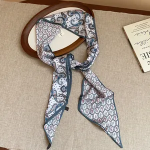 Macro view of vintage paisley silk scarf necklace with luxurious fabric texture details