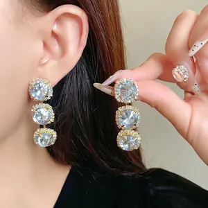 Luxury triple stacked round crystal drop earrings with pavé set border decoration