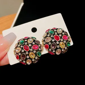 Detailed view of vintage court-style dome earrings with multi-color faceted gemstones