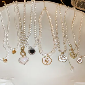 Detailed view of elegant French style pearl necklaces with heart and floral charms