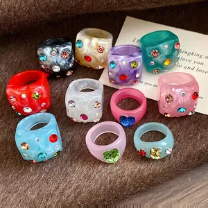 Colorful Dopamine style resin rings with sparkly rhinestones in various vibrant designs