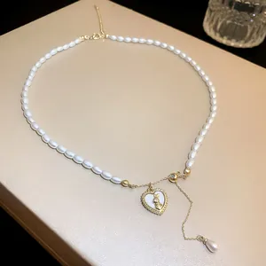Detailed view of elegant mermaid pearl necklace with a gold rabbit heart pendant.