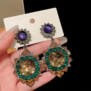 Detailed macro shot of vintage palace style geometric earrings with multi-color rhinestones