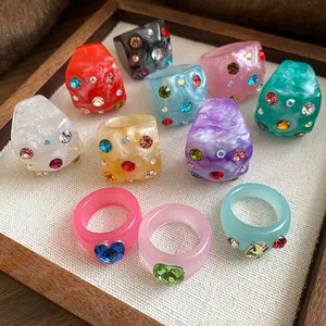 Vibrant colorful resin rings with sparkling rhinestones in a trendy dopamine color palette