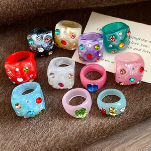 Detailed macro view of colorful resin rings with sparkling rhinestone embellishments