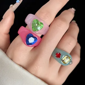 Macro view of dopamine style resin rings featuring sparkling heart-shaped gemstones
