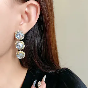 Elegant three-tier blue crystal drop earrings with sparkling diamond border detail