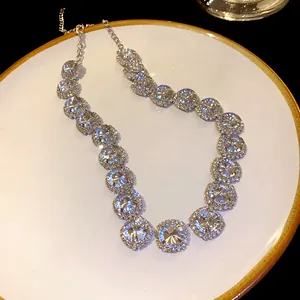 Detail view of a luxury necklace with large round rhinestones on a white plate