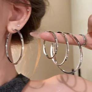 Minimalist silver oversized hoop earrings for women, featuring diverse sizes and sleek design