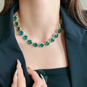 Detail macro shot of luxury emerald green rhinestone choker necklace on model's neck
