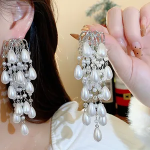 Elegant French style water drop pearl tassel earrings shown worn for an exquisite look