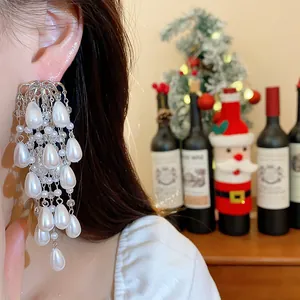 Close-up of elegant French court style waterdrop pearl tassel earrings worn by a model