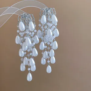 Close-up of elegant French court style tassel earrings with white teardrop pearls